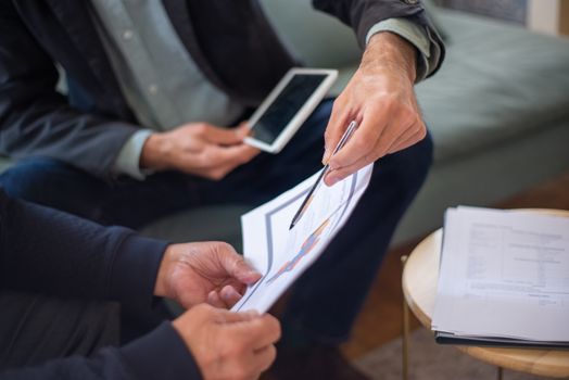 Home Close-up of two business professionals discussing documents in a meeting.